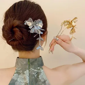 Detailed view of elegant flower hairpins with rhinestones and tassels worn by model