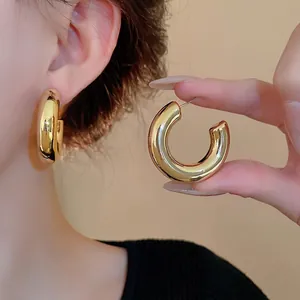 Chunky minimalist gold C-shaped hoop earrings with hypoallergenic steel needles for women