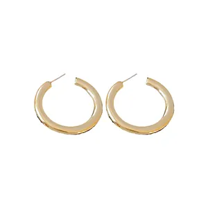Elegant gold C-shaped hoop earrings with a minimalist polished finish for daily wear.