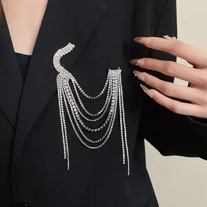 Detailed macro view of elegant rhinestone multi-layer tassel brooch pinned on blazer