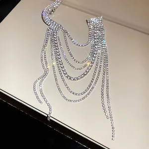 Sparkling multi-layer rhinestone tassel brooch detail in elegant silver finish