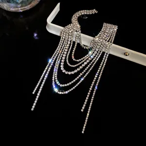 Detail view of a multi-layer rhinestone tassel brooch with sparkling crystal chains.