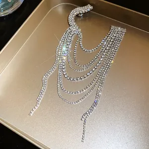 Detailed view of luxury multi-layer rhinestone tassel brooch with sparkling crystals