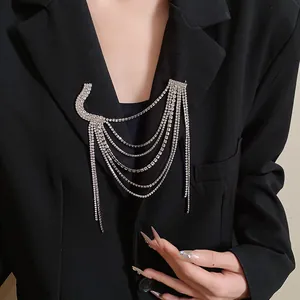 Close-up of elegant multi-layered silver rhinestone tassel brooch on black blazer