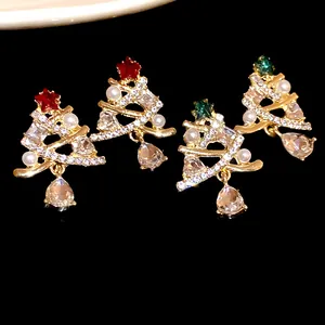 Primo piano dei festosi orecchini ad albero di Natale con strass scintillanti e perle