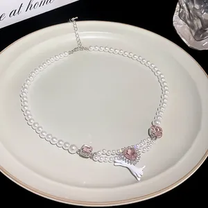 Baroque pearl necklace detail with pink crystals and cute white animal charm