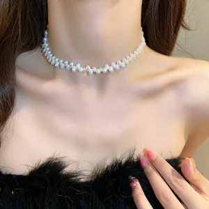 Detailed view of an elegant French Baroque pearl choker on a female model's neck