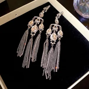 Elegant oversized pear-shaped rhinestone tassel drop earrings with a luxury silver finish