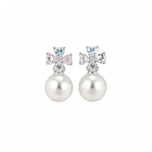 Elegant flower zircon stud earrings with large white pearl drop in a silver-toned finish