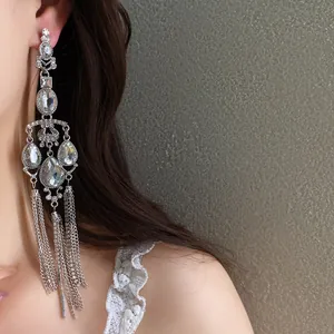 Close-up of glamorous silver-tone tassel earrings with rhinestones and waterdrop crystals