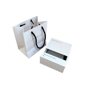 Elegant white jewelry gift box and matching paper handbag with black rope handles