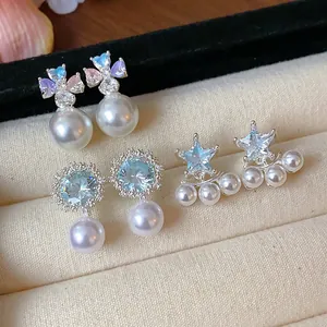 Macro detail view of elegant silver zircon star and flower pearl stud earrings collection