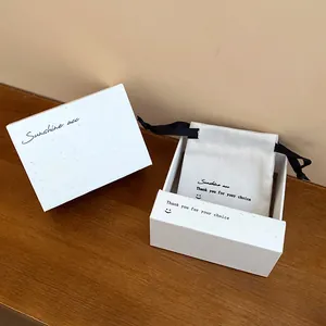 Detailed view of white speckled jewelry gift box set with matching drawstring pouch