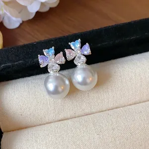 Elegant flower pearl stud earrings with colorful heart-shaped cubic zirconia detail