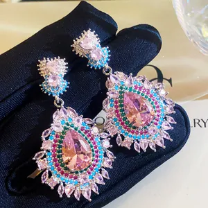 Macro view of vintage palace style earrings with pink teardrop zirconia