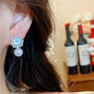 Detailed close-up view of an elegant zircon star flower earring with a pearl drop