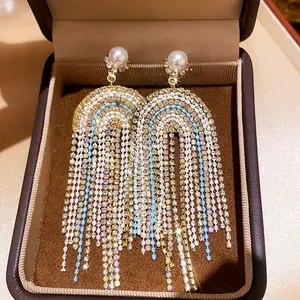 Close-up of elegant court-style tassel earrings with pearls and crystals in a gift box