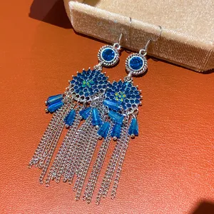 Detail view of blue zircon tassel earrings with vintage palace style hollow design.