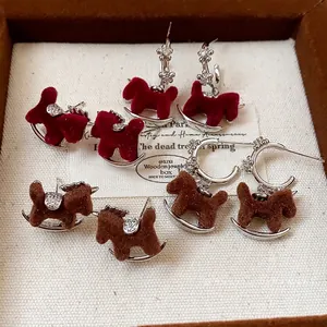 Vintage flocked rocking horse stud earrings with silver needles and zircons in red and brown.