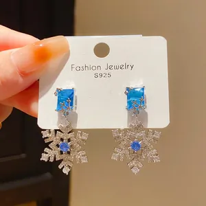 Macro view of vintage style S925 silver snowflake earrings with sparkling blue zircon