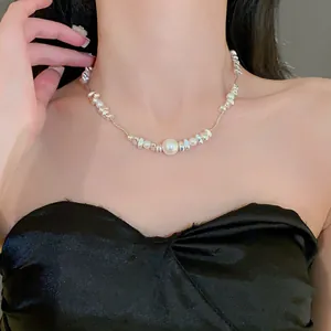 Close-up view of a titanium steel necklace with crushed silver beads and pearls on model.