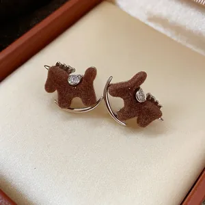 Detailed view of brown flocked rocking horse stud earrings with zirconia accents