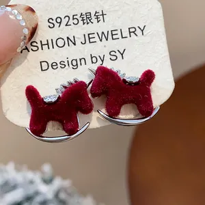 Detailed close-up of red flocked pony stud earrings with S925 silver needles and zircon