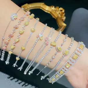 Detailed close-up of multiple luxury zircon heart and leaf bracelets on a female arm