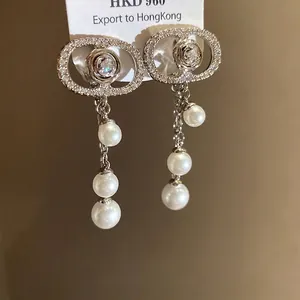 Elegant 18k gold plated oval zirconia ear clips featuring delicate pearl tassels design