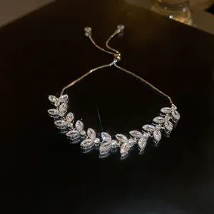 Detailed macro view of a sparkling zircon leaf bracelet with adjustable chain