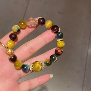 Detailed close-up of a multi-color tiger's eye stone bracelet with clear crystal