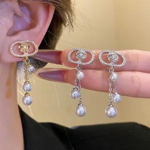 Detailed view of 18k gold plated oval zircon earrings with elegant pearl tassels