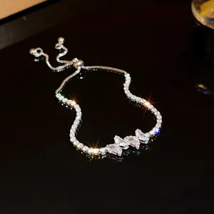 Close-up of elegant silver zircon bracelet with marquise-cut stones on reflective surface