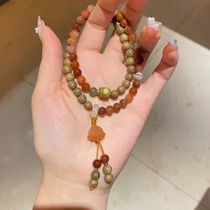 Close-up view of a New Chinese style bracelet featuring red agate and elegant wooden beads