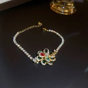 Close-up of golden tennis bracelet featuring a multi-colored zircon flower motif