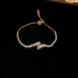 Close-up of elegant gold geometric zircon bracelet with adjustable slider clasp