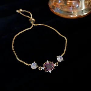 Elegant adjustable gold box chain bracelet featuring a purple rectangular zircon gem