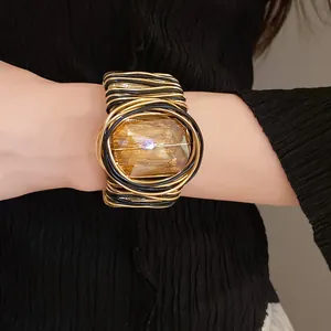 Vista dettagliata di un bracciale rigido bohemian con vetro quadrato color ambra
