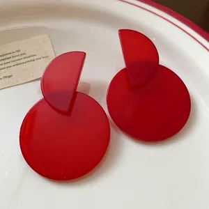 Close-up of elegant retro red geometric resin earrings with a unique translucent finish