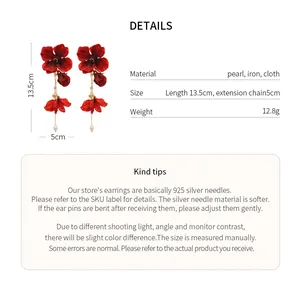 Detailed view of long red fabric flower tassel earrings with elegant pearl accents.