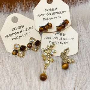 Detailed view of vintage asymmetric floral and butterfly resin earrings with S925 silver needles