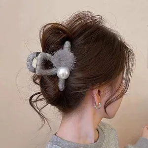 Elegant grey plush hair claw clip with pearl and pom-pom detail for stylish women