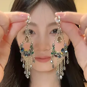 Ethnic style water-drop fringe earrings with colorful beads shown on an Asian model.