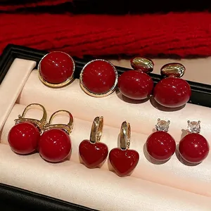 Collection of four pairs of vintage red festive earrings in a premium jewelry box