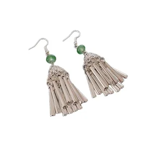 Ethnic style silver tassel earrings with green bead accents on a white background