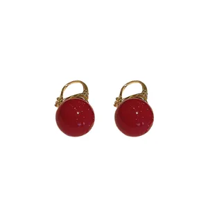 Elegant red pearl drop earrings with gold-tone accents for festive and vintage style