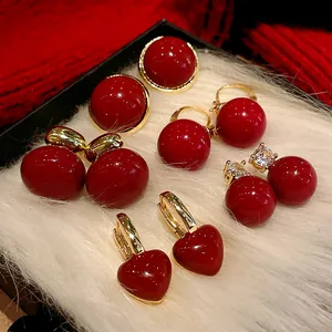 Detailed view of an elegant red earrings collection in various retro festive styles