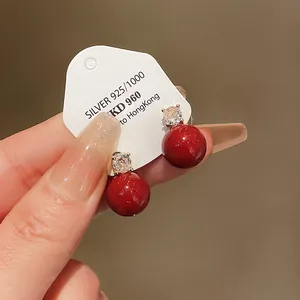 Close-up detail of elegant vintage red pearl earrings with zircon and S925 silver needle