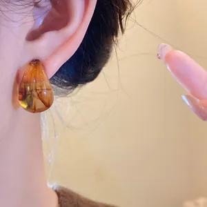 Detailed close-up showing the marbled texture of a vintage acrylic teardrop earring