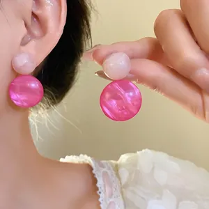 Elegant pink marbled resin geometric drop earrings with silver needles for women.